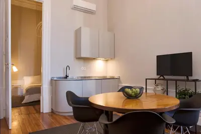 a kitchen and dining room with a table and chairs at AD Apartment - Solar da Avenida in Porto