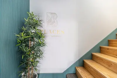 a sign on a wall next to stairs with plants at OX Apartments B Places in Porto