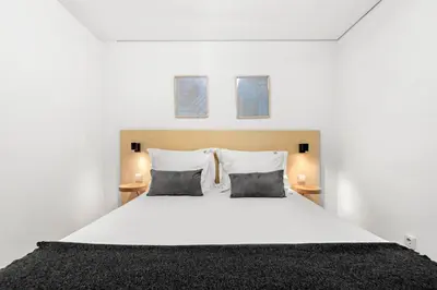 a bedroom with a large white bed with two pillows at OX Apartments B Places in Porto