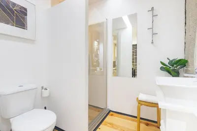 a bathroom with a toilet and a sink at OX Apartments B Places in Porto