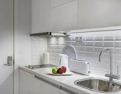 a kitchen counter with a sink and fruit on a plate at ApartmentsPorto - Bombarda 451 in Porto