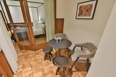 a table and chairs in a room with a bedroom at Republica 157 Guest House in Porto