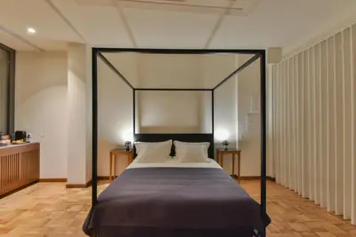a bedroom with a canopy bed with two pillows at Republica 157 Guest House in Porto