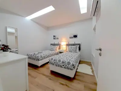 a white room with two beds and a mirror at Casa de Cristal by Oporto Soul in Porto