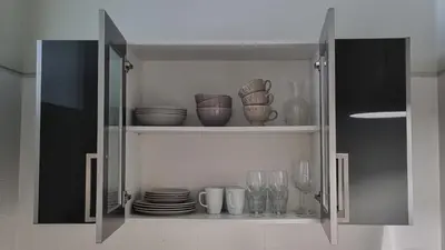 a cabinet filled with plates and glasses and dishes at Oporto Downtown in Porto