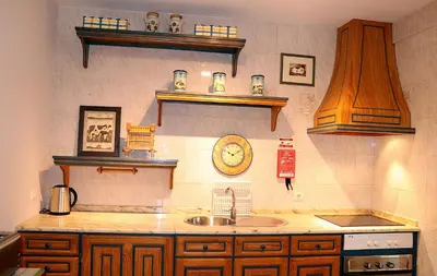 a kitchen with a sink and a clock on the wall at Porto Patricio Apartments in Porto