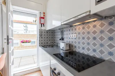 a kitchen with a counter top and a sink at Porto Haven - Terrace Penthouse in Downtown in Porto