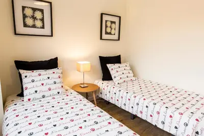 a bedroom with two beds and a table with a lamp at Porto Haven - Terrace Penthouse in Downtown in Porto