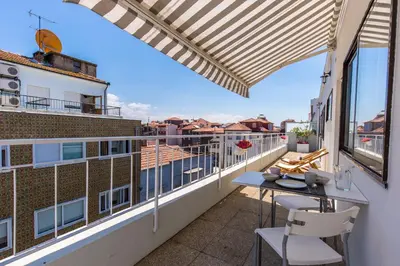 a balcony with a table and chairs on a building at Porto Haven - Terrace Penthouse in Downtown in Porto