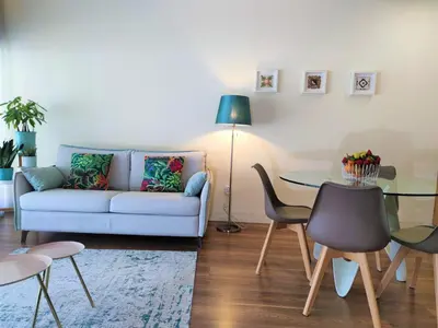 a living room with a couch and a table at Trindade Apartments in Porto