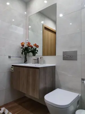 a bathroom with a sink and a toilet and a mirror at Trindade Apartments in Porto