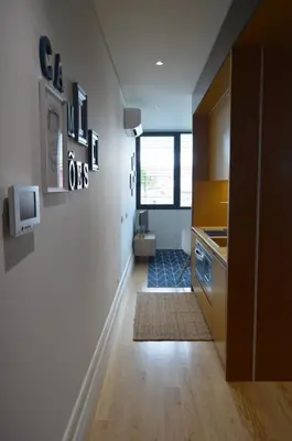 a hallway of a kitchen with a sink and a counter at Camões by Trindade Sweet Home in Porto