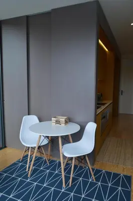 a table and two chairs in a room at Camões by Trindade Sweet Home in Porto