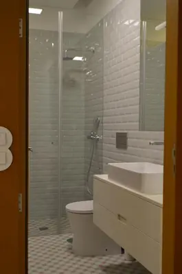 a bathroom with a shower and a toilet and a sink at Camões by Trindade Sweet Home in Porto