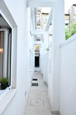 an empty hallway of a building with white walls at Mezzanine cozy house in Porto