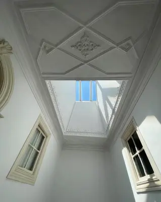 a ceiling with two windows in a white room at Casa Portugueza Experience in Porto