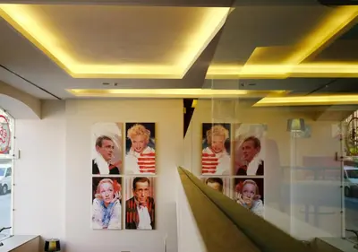 a display case with pictures of people on a wall at Moov Hotel Porto Centro in Porto