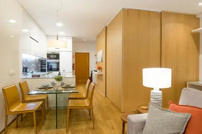 a kitchen and living room with a table and chairs at Merc Porto Cedofeita Place in Porto