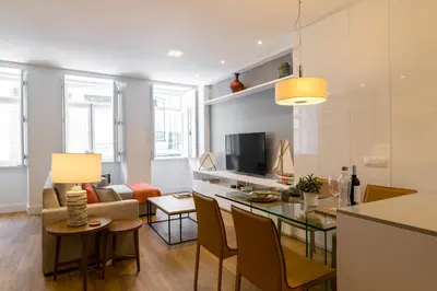 a living room with a table and a couch at Merc Porto Cedofeita Place in Porto