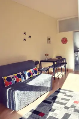 a living room with a bed and a dining room table at A Casa da Maria in Porto