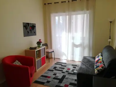 a living room with a couch and a chair and a window at A Casa da Maria in Porto