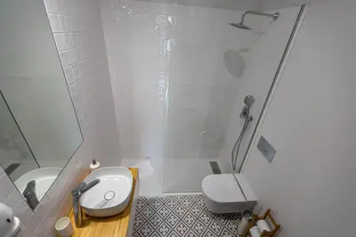 a white bathroom with a shower and a toilet at charm in C - Porto Center Apartment in Porto