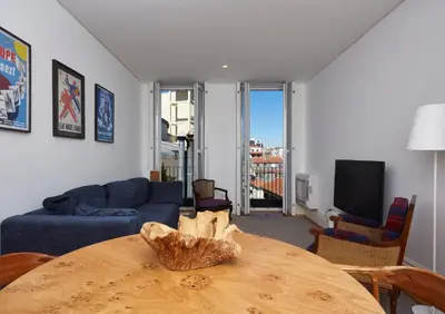 a living room with a table and a couch at Downtown Colosseum Apartments in Porto