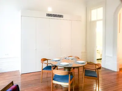 a dining room with a wooden table and chairs at Downtown Colosseum Apartments in Porto