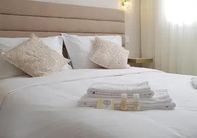 a white bed with towels and pillows on it at Min Porto Inn in Porto