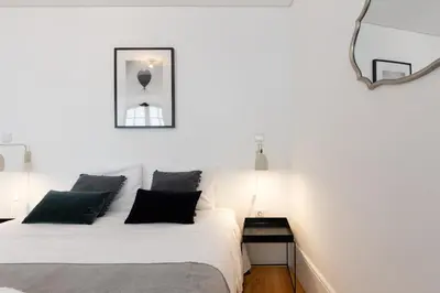 two beds in a small room with white walls at Douro Virtudes Apartments Historical Center in Porto