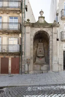 a building with a large bell on the side of it at Douro Virtudes Apartments Historical Center in Porto