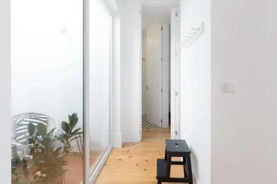 a hallway with a large mirror in a white room at Douro Virtudes Apartments Historical Center in Porto