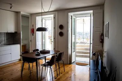 a kitchen and dining room with a table and chairs at Douro Virtudes Apartments Historical Center in Porto