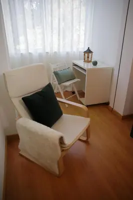 a living room with a chair and a desk at Braancamp 65 in Porto