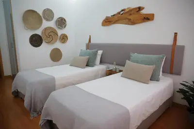two beds in a room with hats on the wall at Braancamp 65 in Porto