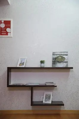 a shelf on a wall with pictures on it at Braancamp 65 in Porto
