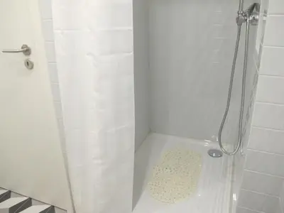a bathroom with a shower with a shower curtain at Oporto City Cottage in Porto