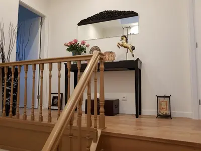 a staircase in a living room with a stair case at Luxurious Pink House and Parking in Porto