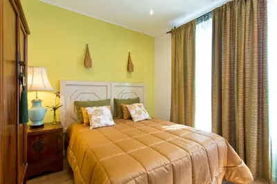 a bedroom with a bed and a large window at Luxurious Pink House and Parking in Porto