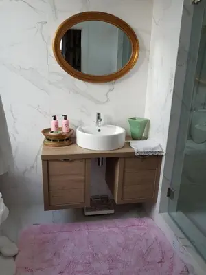 a bathroom with a sink and a mirror at Luxurious Pink House and Parking in Porto