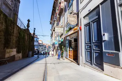 a city street with people walking down the street at YOUROPO - The Tower in Porto