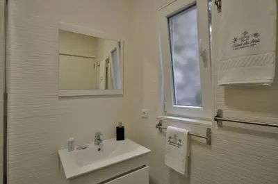 a white bathroom with a sink and a mirror at Casa da Ana - Porto Velho Apt in Porto