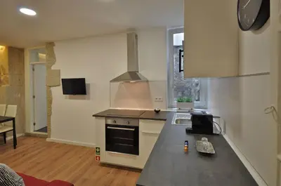 a kitchen with a sink and a stove top oven at Casa da Ana - Porto Velho Apt in Porto