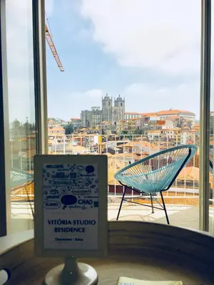 a sign in front of a window with a view of a city at Vitoria Studio Residence - Downtown in Porto