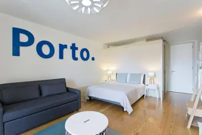 a living room with a bed and a couch at Vitoria Studio Residence - Downtown in Porto
