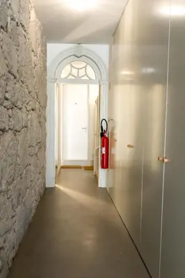 a hallway with a fire hydrant next to a door at Vitoria Studio Residence - Downtown in Porto