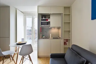 a kitchen with a couch and a table in a room at Vitoria Studio Residence - Downtown in Porto