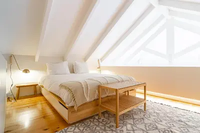 a bedroom with a bed and a window at Casulo Loft - Oporto Downtown in Porto