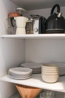 a kitchen shelf with plates and a tea pot at Casulo Loft - Oporto Downtown in Porto