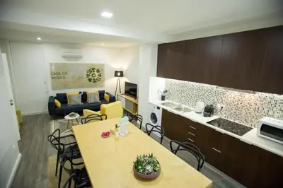 a kitchen and a living room with a table and chairs at Boavista Premium Family & Business by Porto City Hosts in Porto
